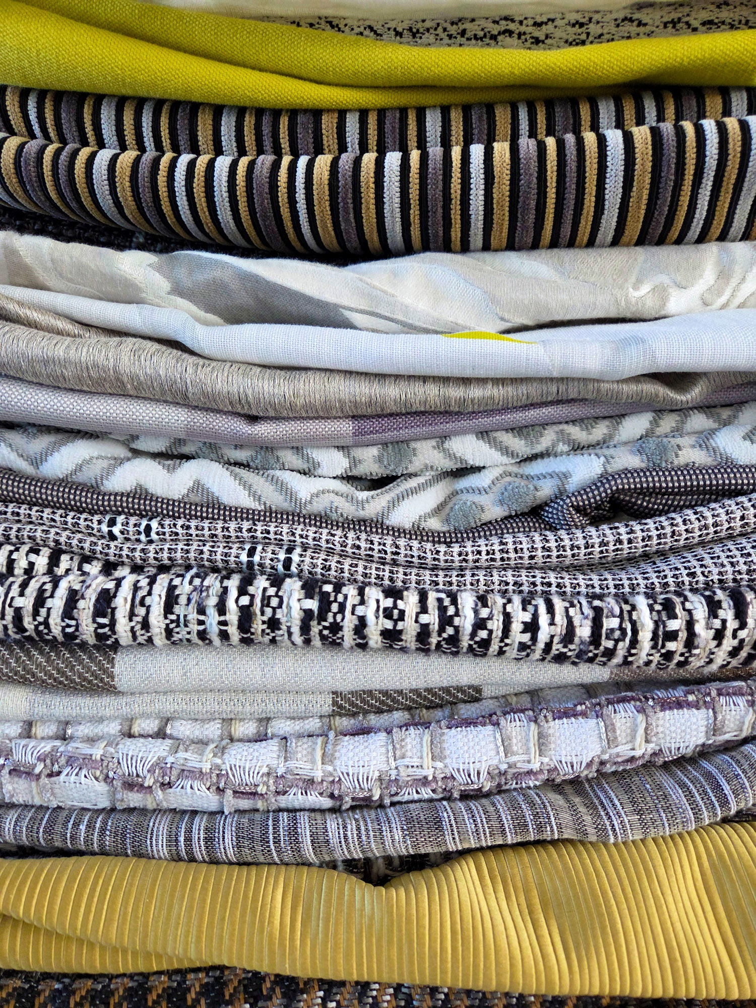 Neatly stacked curtains in multiple colors from sustainable deadstock meterware.